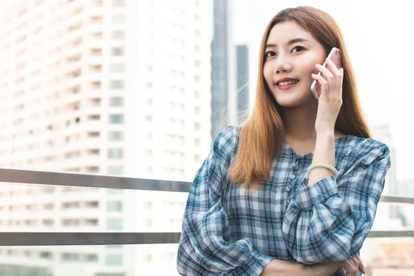 Portrait of young beautiful asian woman using smart phone selfie live in roof top. Happy asian girl online influencer blogger. vlogging talking on live stream.