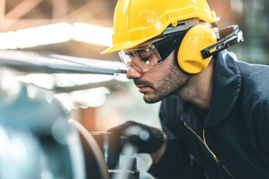 Hard Hatks Endüstrisi Mühendisleri. Ağır Sanayi Üretim Fabrikasında çalışıyorlar. Fabrikanın içinde endüstriyel işçiler. Endüstriyel fabrikada çalışan bir adam..