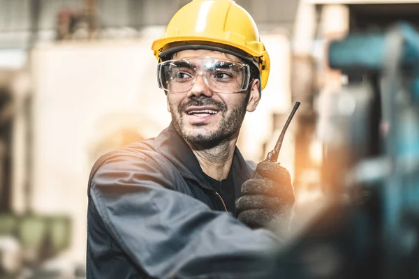 Industrial Engineers in Hard Hats.Work at the Heavy Industry Manufacturing Factory.industrial worker indoors in factory. man working in an industrial factory.Safety first concept.