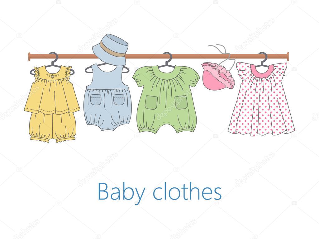 Rack with baby clothes on hangers