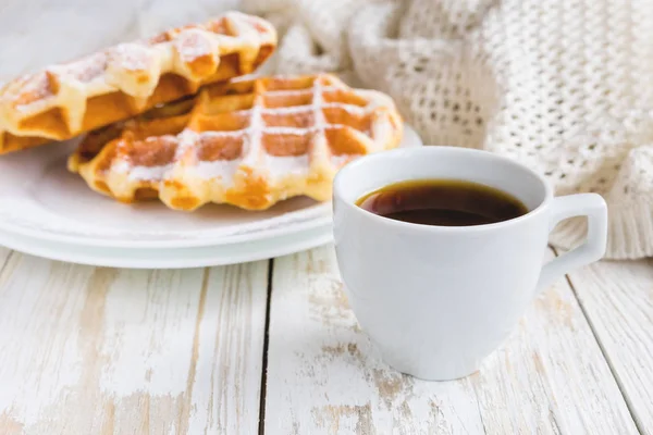 Warm knitted plaid, cup of coffee and Belgium waffles — Stock Photo, Image