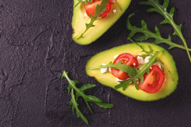 Beyaz peynir, roka ve domates ile doldurulmuş avokado