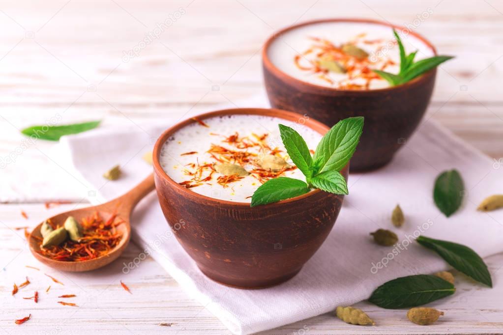 Traditional Indian lassi curd with cardamon, mint and saffron