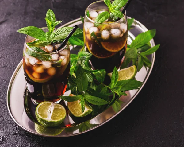 Cuba Libre cocktail with cola, lime, rum and peppermint