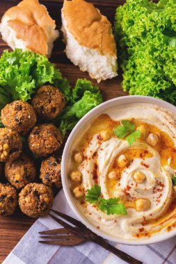 Hummus, falafel and chickpea served with salad and pita clipart