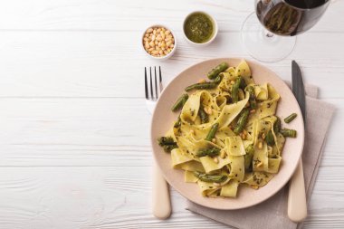Vegetarian pappardelle pasta with green bean, pesto, pine nuts clipart