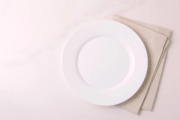Esperienza alimentare. Piatto bianco vuoto, tovagliolo. Vista dall'alto, copyspace . — Foto Stock