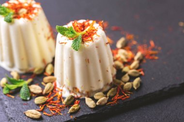 Indian kulfi dessert, ice cream with safron, mint, nuts clipart