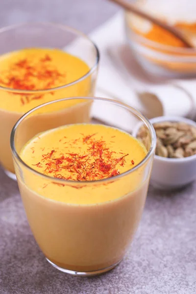 Indian turmeric milk with saffron, cardamom and turmeric. Copysp