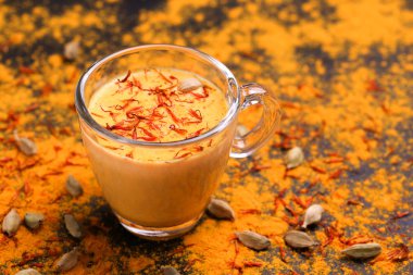 Indian turmeric milk with saffron, cardamom and turmeric. Copysp clipart
