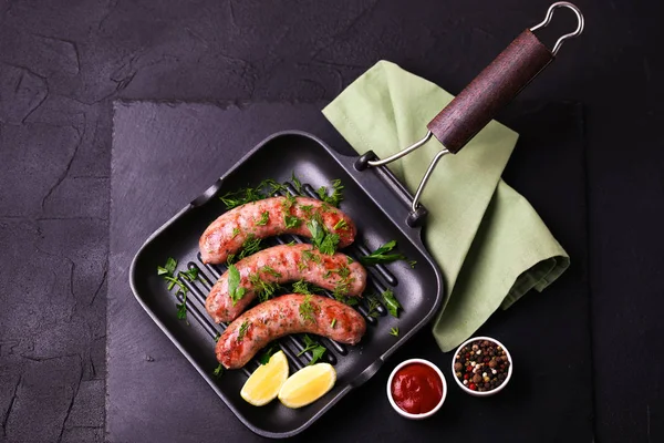 stock image Grilled sausages with lime on iron grill pan