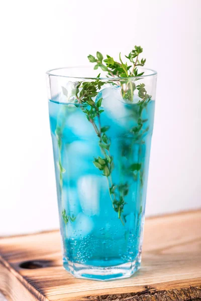 Ice Blue cocktail with thyme. Blue curacao liqueur. Summer