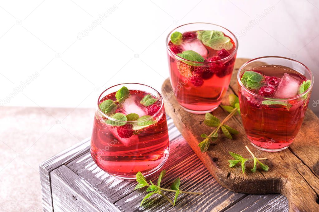 Aperitif with campari, mint and raspberry. Iced lemonade