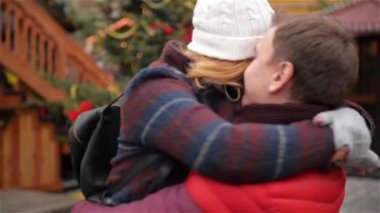 Romantik Çift üzerinde Noel Fuarı, adam onun sarıldı kız arkadaşı etrafında dönen, Xmas ağacı arka planda