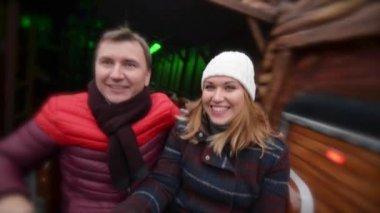 Eğlence cazibe belgili tanımlık Noel çarşı, genç aile Xmas fuarda gülüyor sahip çift gülüyor. Mutlu Noeller ve mutlu yeni yıl