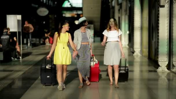 Elegantes tres amigas tienen un viaje de verano juntas. Increíbles morenas con documentos, entradas y grandes bolsas de viaje en las manos en el aeropuerto . — Vídeos de Stock