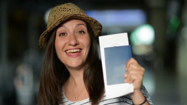 Closeup Portrait of Attractive Smiling Brunette in Summer Hat Waiting for Her Airplane at the Airport with Ticket and Passport in the Hands. — Stock Video