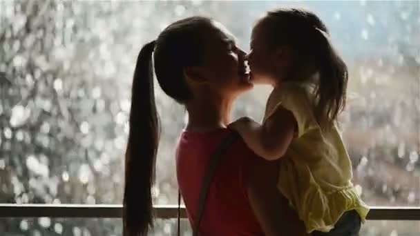 Happy Mother and Daughter Having Fun at Mothers Day. Waterfall is on Background. Mother Holding Her Kid. — Stock Video