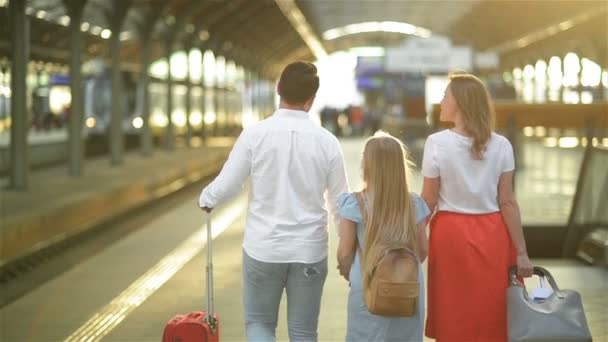 Young Family with Cute Daughter, Walking On Railway Platform Holding Suitcase. Best Trip and Vacations Concept. Caucasian Appearance. — Stock Video
