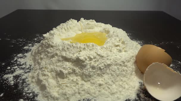 Egg dropping into flour, slow motion HD — Stock Video