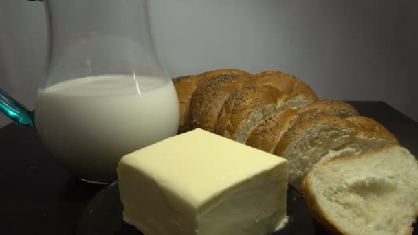 Bröd, mjölk och smör på träbord, nära Hd — Stockvideo
