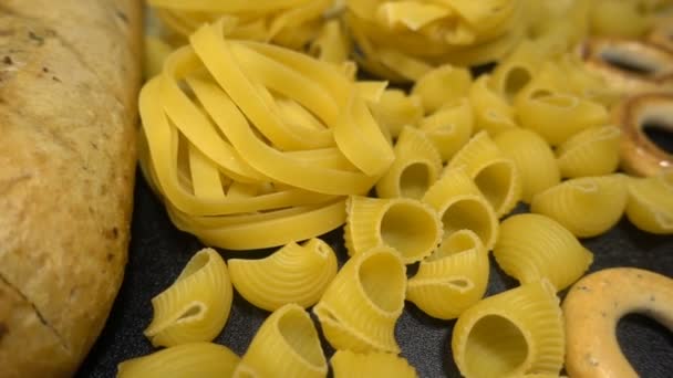 Background or texture of pasta close-up. Different types of pasta on the table shot close hd slow. Flour products — Stock Video