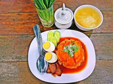 Mangalda kırmızı domuz soslu pilav, haşlanmış yumurta, taze soğan ve et suyu ile