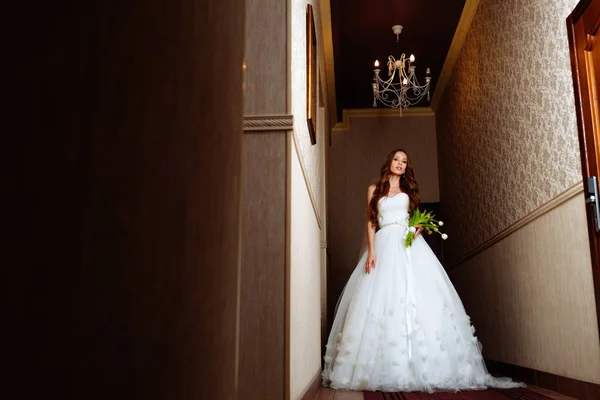 Bride in wedding dress at luxurious suites. Bride in a luxury apartment in a wedding dress.