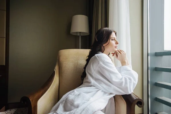 stock image Girl sitting on the armchair in a beautiful position