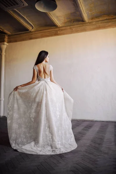 Bride in wedding dress at luxurious studies — Stock Photo, Image