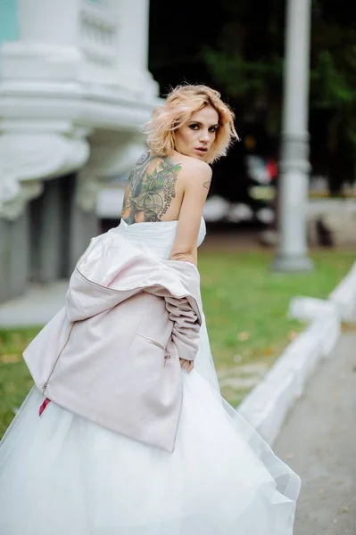 Beautiful bride with tattoo at wedding morning