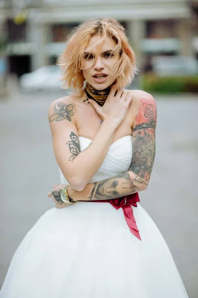 Beautiful bride with tattoo at wedding morning