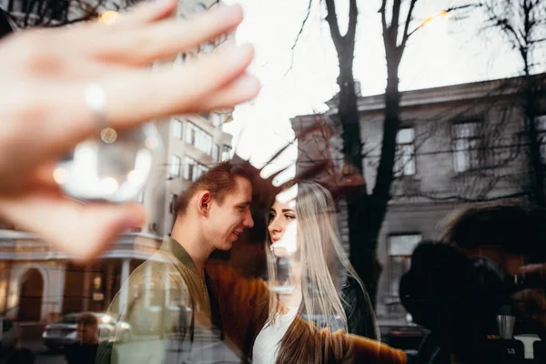 True love emotions of joyful cute couple enjoying time together outdoor in city. Lovely happy moments, having fun, smiling in love on the background of the city.