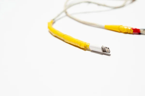 A charging cable is damaged on white background