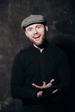 Give me and  inviting to come. Close up portrait of happy handsome young man with a beard, standing and stern looking into the camera.