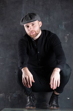 Portrait of handsome business man. Boy sitting on table.