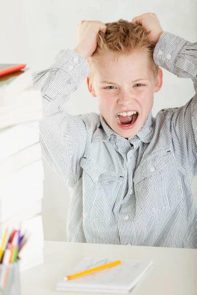 Unhappy frustrated boy doing homework — Stock Photo, Image