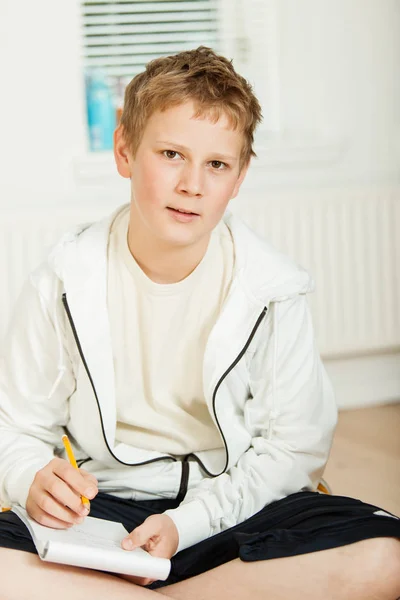 Teenage boy doing his homework — Stock Photo, Image