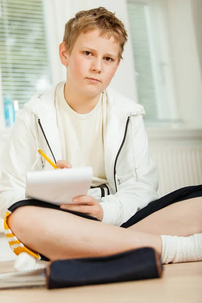 Adolescente chico haciendo su tarea — Foto de Stock