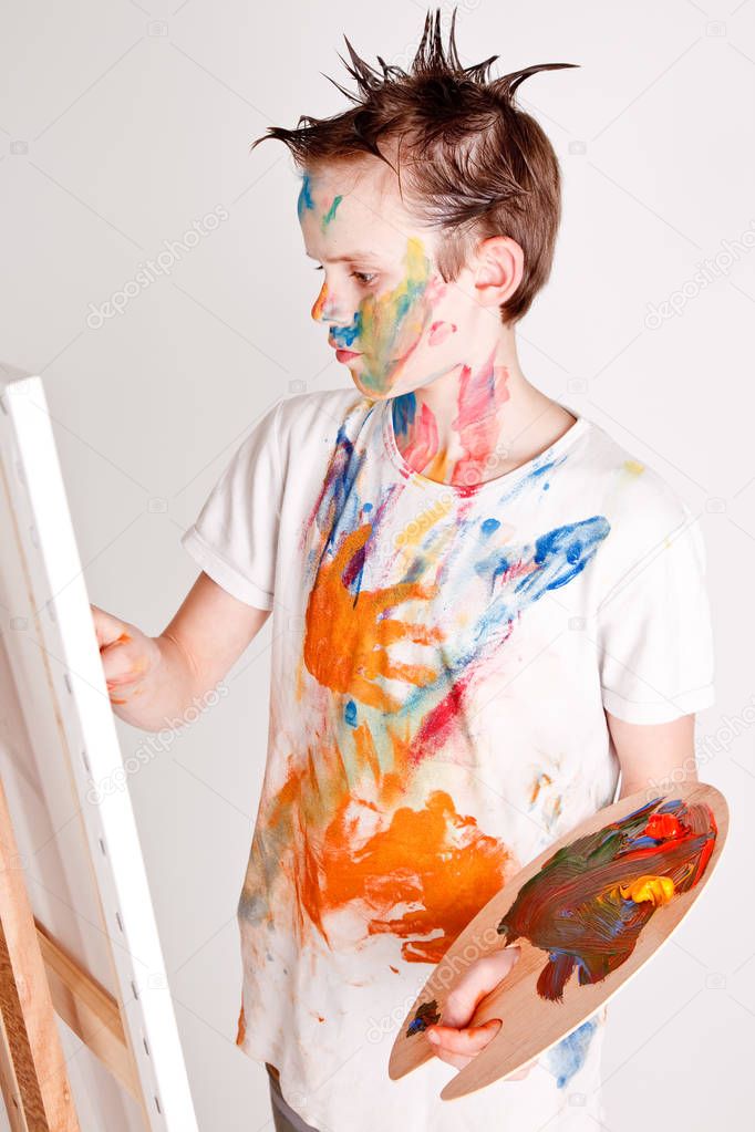 Boy painting on a canvas