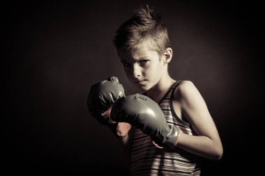 Boxer Boy with Gloves Frowning at the Camera clipart