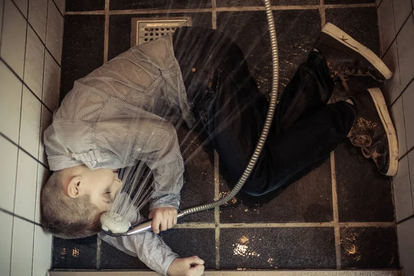 Boy Holding Shower Head Collapsed in the Rest Room — Stock Photo, Image