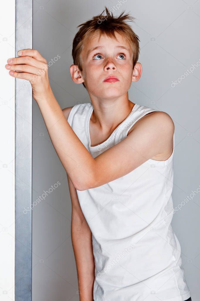 Boy looking frightened from doorway