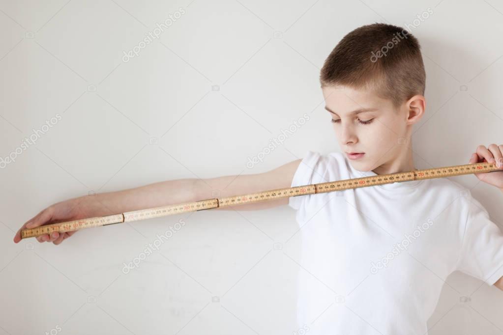 Handsome White Young Boy Holding a Meter Stick