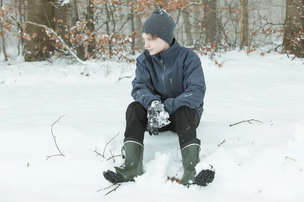 Spokojne dziecko siadając po zabawie w śniegu — Zdjęcie stockowe