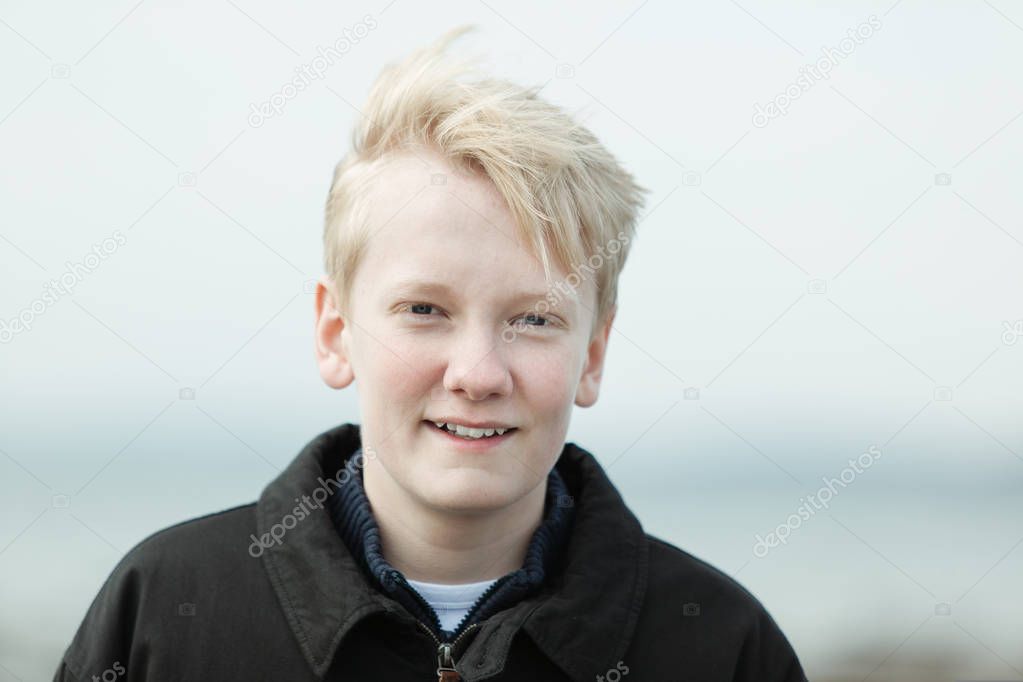 Smiling blond youth in jacket