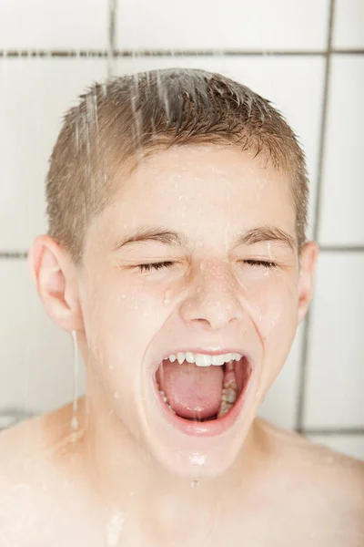 Excited young boy enjoying his shower