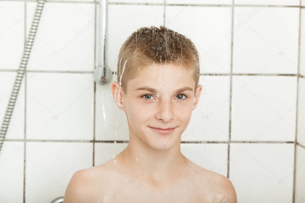 Friendly handsome young boy having a shower