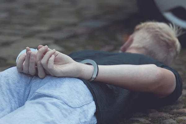 Teenage boy with his hands cuffed behind his back — Stock Photo, Image