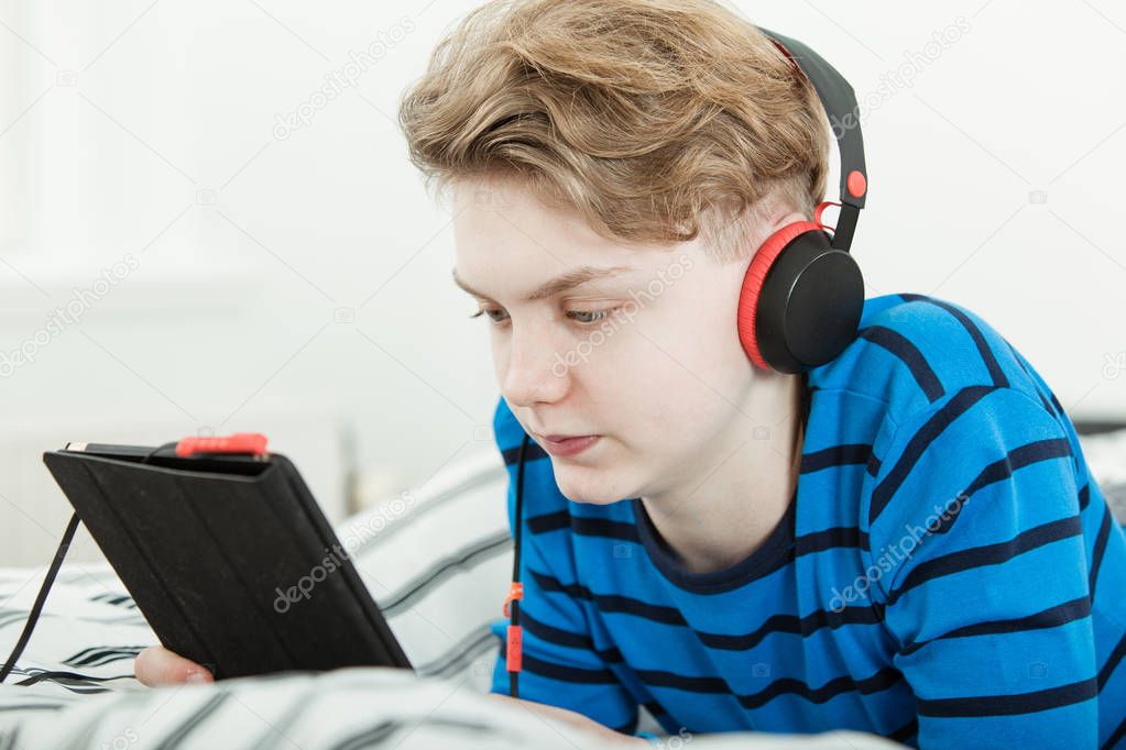 Attractive teenage boy listening to music